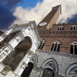 Campanile or Sienna Tower view in Piazza del campo, or Il Palio, the main square. Sienna, Italy.