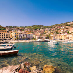 Porto Santo Stefano, Italy - June 24, 2017: Harbor seafront and village skyline, italian travel destination. Monte Argentario, Tuscany, Italy.