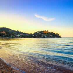Porto Santo Stefano, headland and bay beach at sunset in Monte Argentario, Maremma Tuscany, Italy